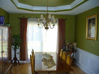 Dining room with crown molding, an inviting chande