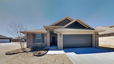 Ranch-style house featuring brick siding, a garage, and driveway