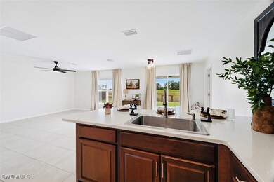 Kitchen with ceiling fan, light tile patterned flo