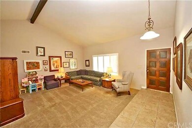 Formal sunken living room under a vaulted beamed c
