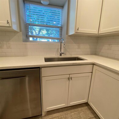 Kitchen featuring stainless steel dishwasher, dec