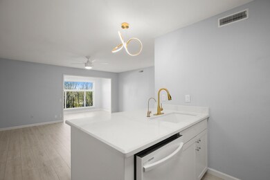 Kitchen featuring white cabinets, visible vents, 