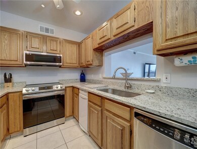 The kitchen offers granite countertops with stainl
