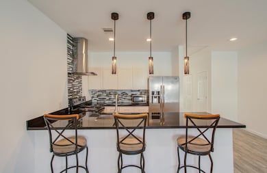 Modern kitchen with a sleek black countertop and b