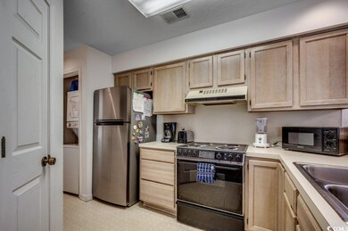 Kitchen with black appliances, light brown cabinet