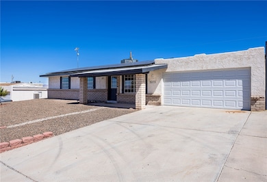 Ranch-style house featuring concrete driveway, roo