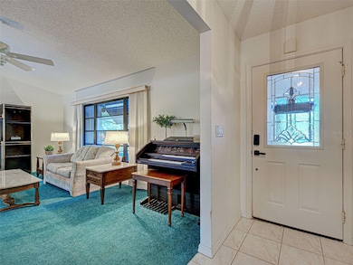 Tasteful front door with mosaic glass insert opens up to the light and bright living room.