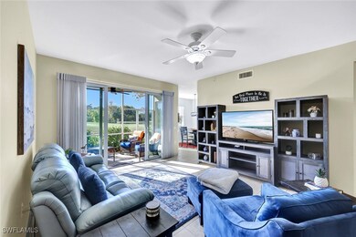 Tiled living room with a fireplace, a ceiling fan,