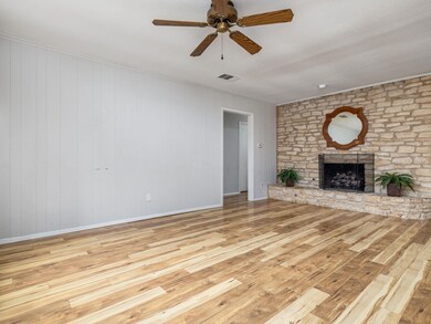 Unfurnished living room featuring wood-type floor