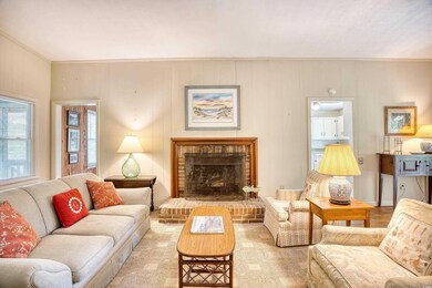 Living room with ornamental molding, a brick firep