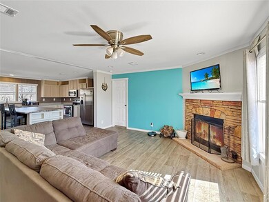 Living area featuring light wood-type flooring, pl