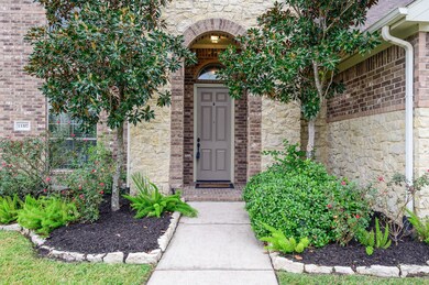 Inviting front patio with brick pavers and manicured landscaping.