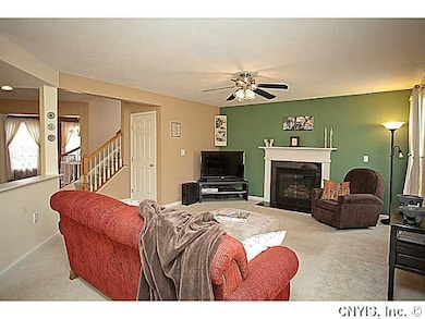 Living Room With it s fireplace and ceiling fan in