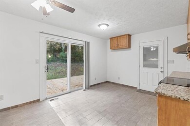 Unfurnished dining area featuring ceiling fan, lig