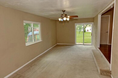 Carpeted family room with slider to patio area and