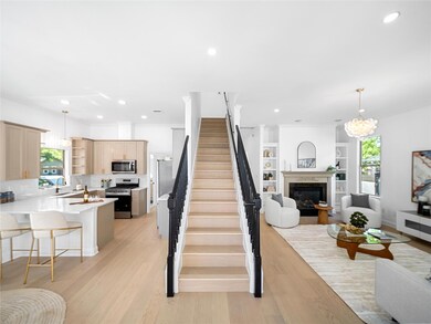 Stairway featuring recessed lighting, a fireplace
