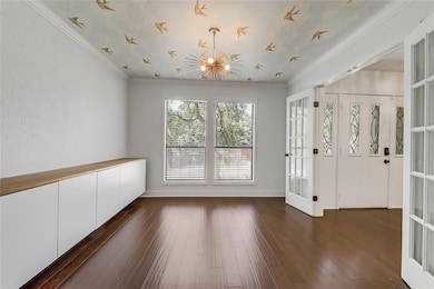 Empty room featuring a chandelier, dark wood-styl