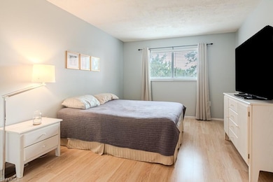 Bedroom featuring a textured ceiling and light har