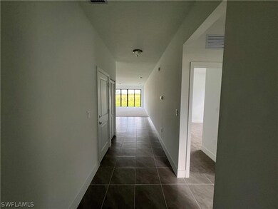 Corridor with dark tile floors