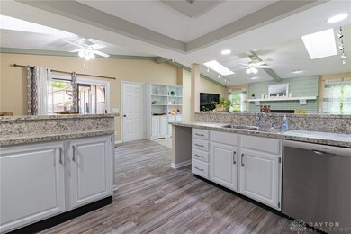 View from kitchen to Family Room at right and Brea