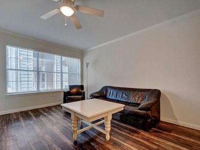 Living area with wood finished floors, ornamental