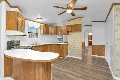 Kitchen with black electric range, extractor fan,