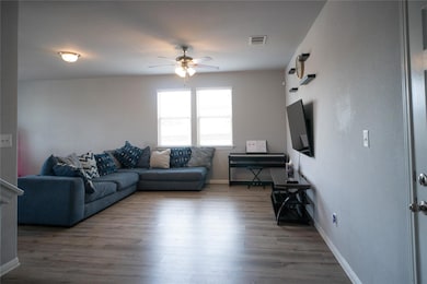 Living area featuring ceiling fan and wood finish