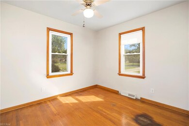 Spare room featuring hardwood flooring and ceiling
