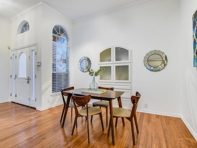 Dining area with crown molding, light wood finish