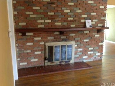Brick Fireplace in Living Room with Large Mantel