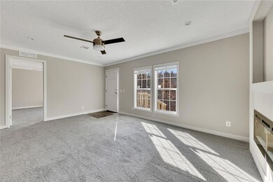 Unfurnished living room featuring ornamental moldi