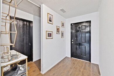 Entryway featuring visible vents, a textured ceili