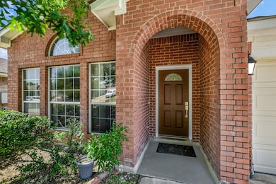 Doorway to property featuring brick siding