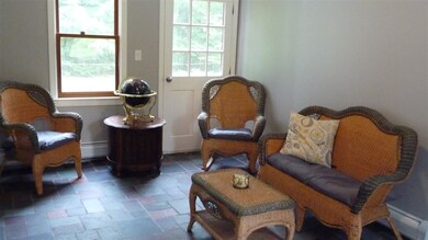 Slate tile floors in this spacious mudroom make it