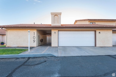 View of front of home featuring stucco siding, a garage, and driveway