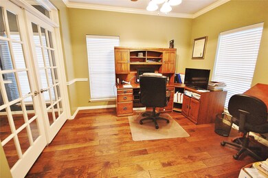 STUDY AT FRONT OF HOME WITH TWO WALLS OF FRENCH DOORS