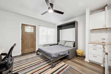 Bedroom with baseboards, light wood-style floors,