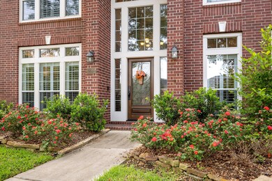 Gorgeous landscaping welcomes you at the front doo