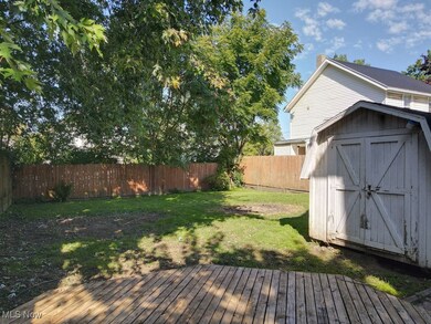 Deck featuring a storage shed and a fenced​​‌​​​​‌​​‌‌​​​‌​​‌‌​​‌‌​‌​​​‌‌​​‌​​​​​‌ backyard