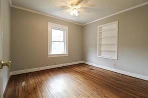 Unfurnished room featuring ceiling fan, baseboards