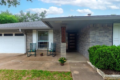 Entrance to property with roof with shingles and 