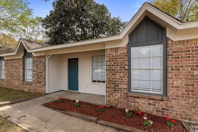 Doorway to property featuring brick siding and boa