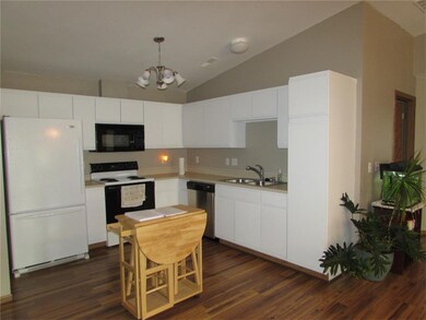 Updated kitchen with fresh paint and new flooring.