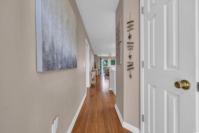 Hallway with baseboards and wood finished floors