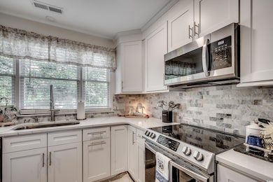 Kitchen with stainless steel appliances, a sink, v