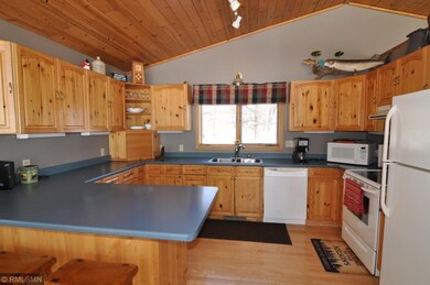 This kitchen has vaulted pine ceilings, knotty pin
