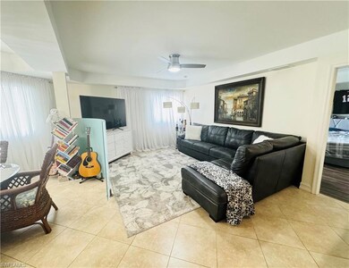 Tiled living room featuring ceiling fan and plenty