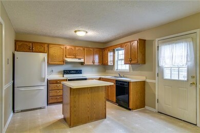 Kitchen is spacious with an island - all appliances stay.
