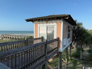 Rear view of house with a deck with water view