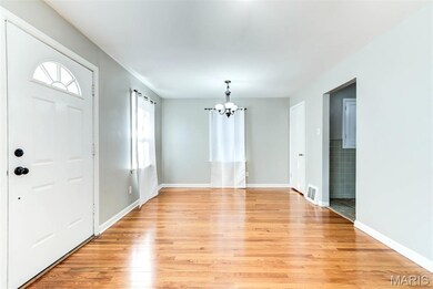 Highlighting Dining area light fixture & light wood flooring